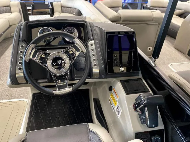 Slide: The Image of 2024 Lusso Ultra-Lounge 25UC boat dashboard with steering wheel and control panel. - 7