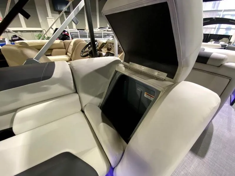 Slide: The Image of 2024 Geneva Cruise SB 22 boat interior with open storage compartment and plush seating. - 20