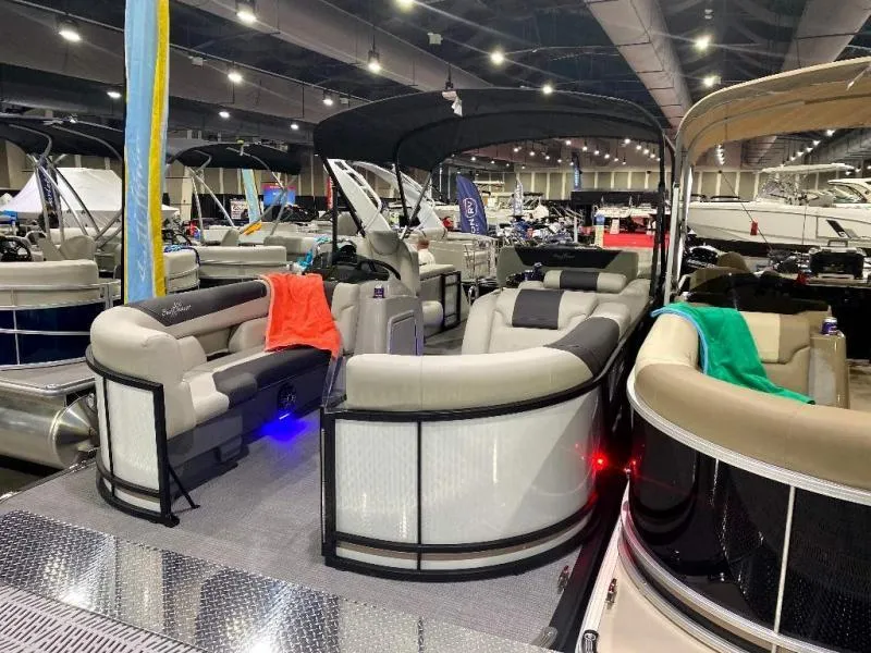 Slide: The Image of 2024 Geneva Cruise SB 22 pontoon boat displayed at an indoor boat show. - 3