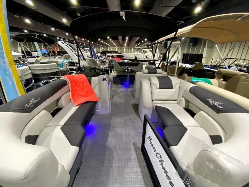 Slide: The Image of 2024 Geneva Cruise SB 22 boat interior with plush seating and ambient lighting at a showroom. - 7