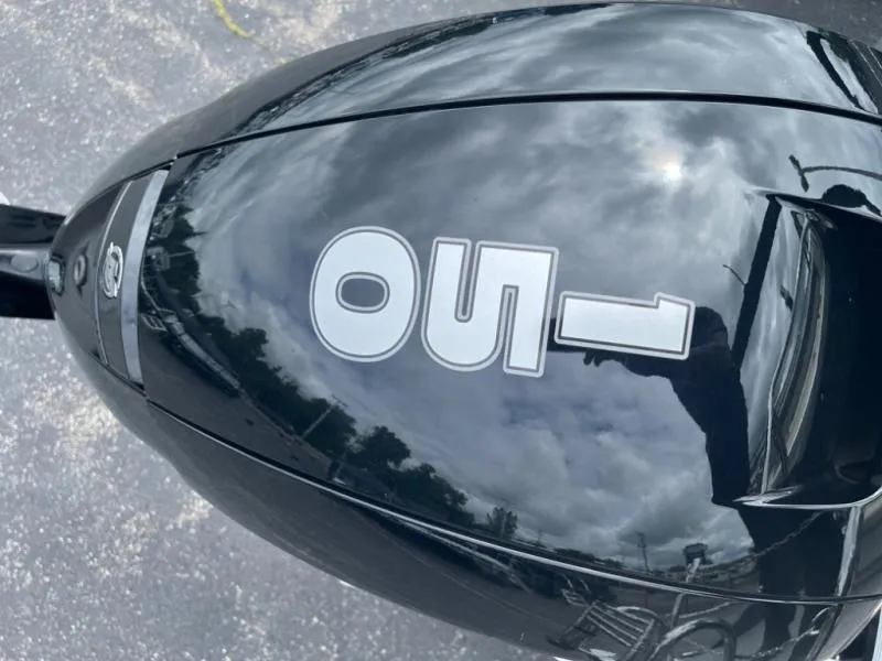 Slide: The Image of Black Aria Ultra-Lounge A22UC 2024 motorcycle with reflective surface and "OUI" decal. - 11