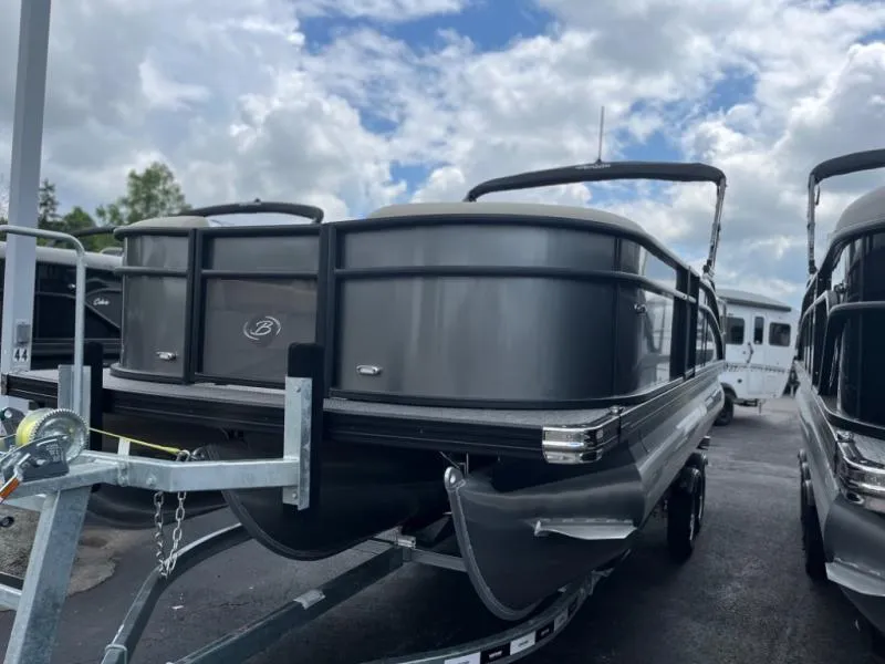 Slide: The Image of 2024 Aria Ultra-Lounge A22UC pontoon boat on trailer under cloudy sky. - 4