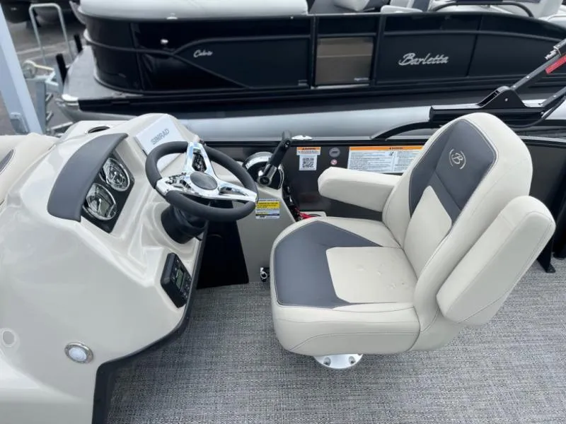 Slide: The Image of 2024 Aria Ultra-Lounge A22UC boat interior with steering wheel and captain's chair. - 8