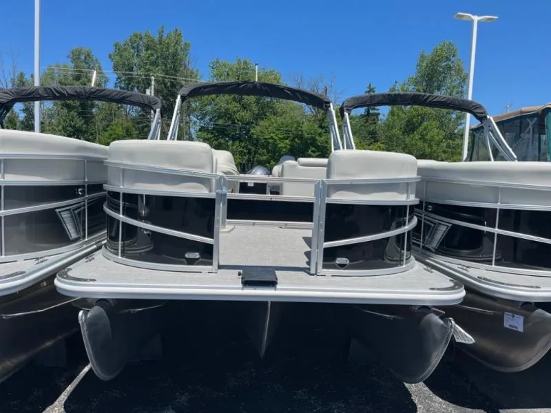 Slide: The Image of 2024 Vista Fish 20 pontoon boat with sleek design, docked outdoors under clear blue sky. - 3