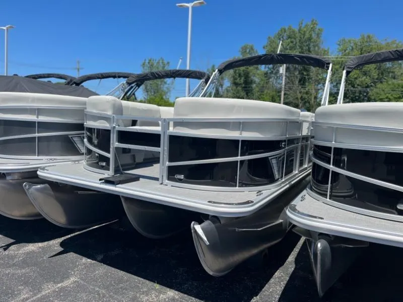 Slide: The Image of 2024 Vista Fish 20 pontoon boats displayed outdoors under clear blue sky. - 4