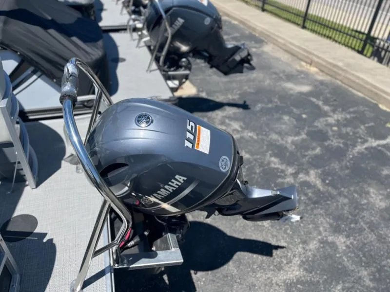 Slide: The Image of Outboard motor on a 2024 Vista 20 LR boat, parked on pavement. - 11