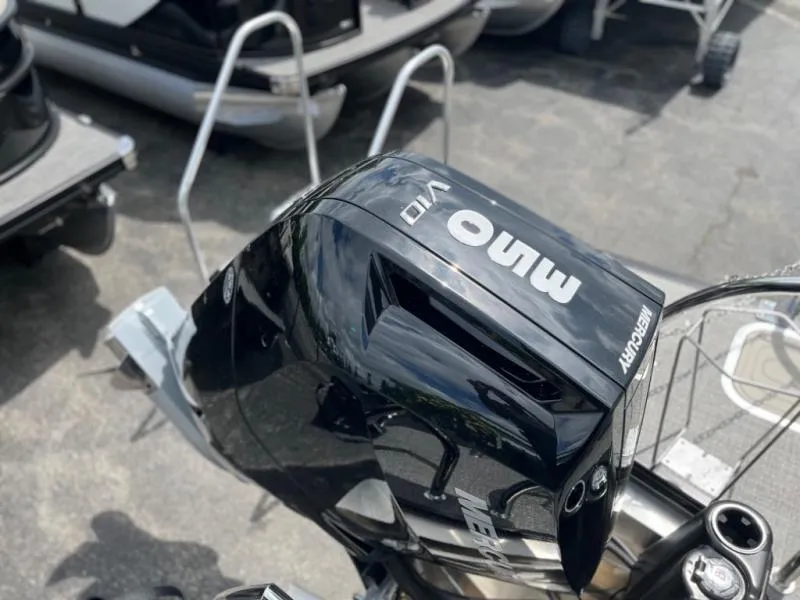 Slide: The Image of 2024 Lusso Ultra-Lounge L23UC with Mercury outboard motor, sleek black design. - 10