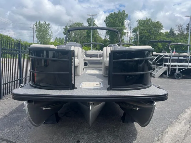 Slide: The Image of 2024 Lusso Ultra-Lounge L23UC pontoon boat with sleek design, parked outdoors. - 4