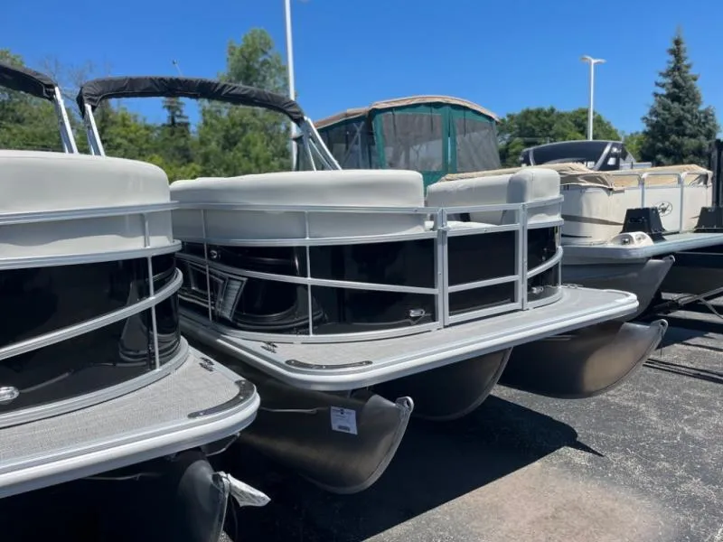 Slide: The Image of 2024 Vista 20 LR pontoon boats displayed outdoors on a sunny day. - 1