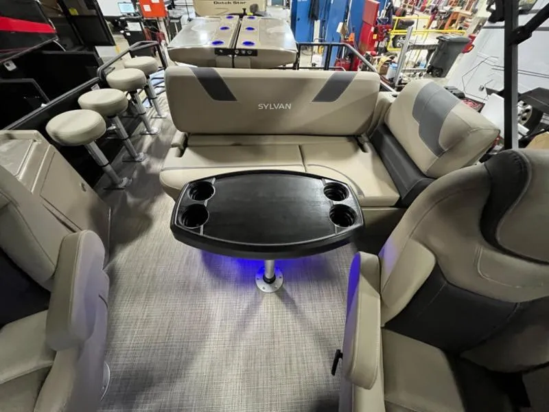 Slide: The Image of Luxurious boat interior with cushioned seating, table, and bar stools, model L3 DLZ DH Bar 2025. - 12