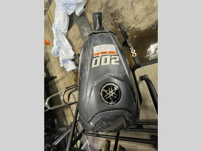 Slide: The Image of 2025 L3 DLZ DH Bar motorcycle fuel tank with "200" decal in a workshop setting. - 16