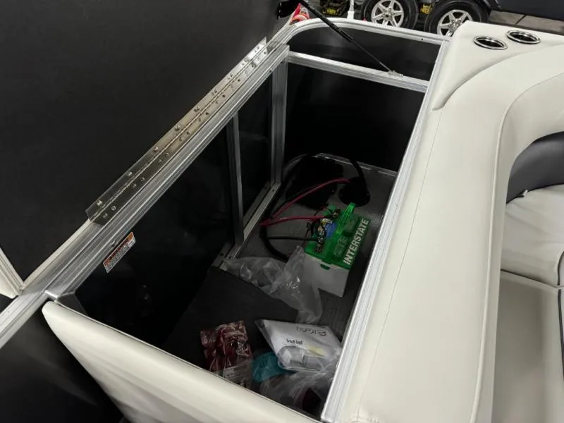 Slide: The Image of Storage compartment in 2025 Mirage Cruise 8520 CRS boat, featuring battery and accessories. - 11