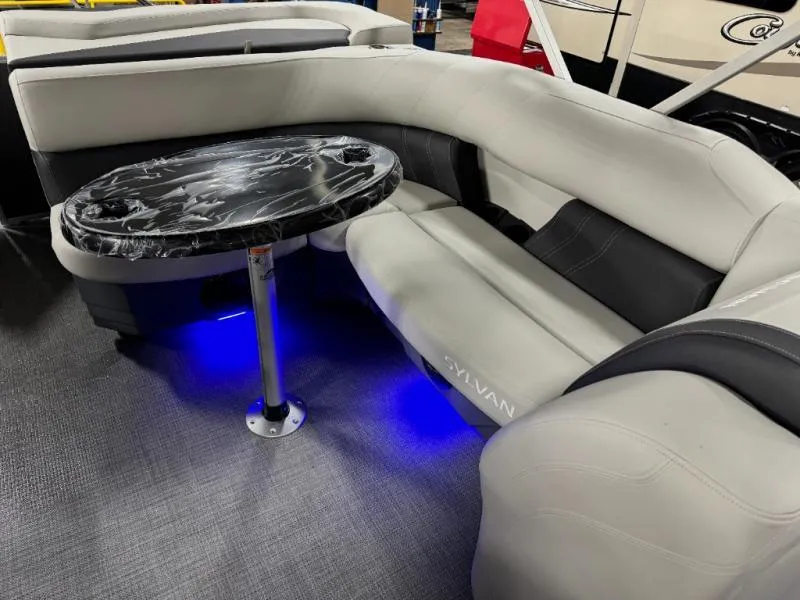 Slide: The Image of Luxurious seating area on 2025 Mirage Cruise 8520 CRS with elegant table and ambient lighting. - 12