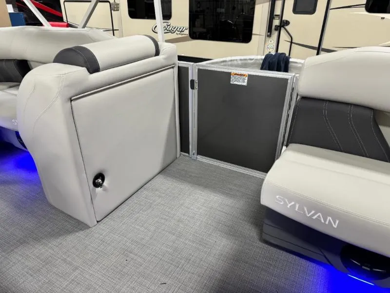 Slide: The Image of Interior of 2025 Mirage Cruise 8520 CRS boat with gray seating and blue lighting. - 22