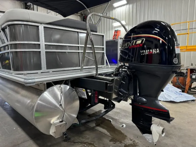 Slide: The Image of 2025 Mirage Cruise 8520 CRS pontoon boat with Yamaha outboard motor in a garage. - 6