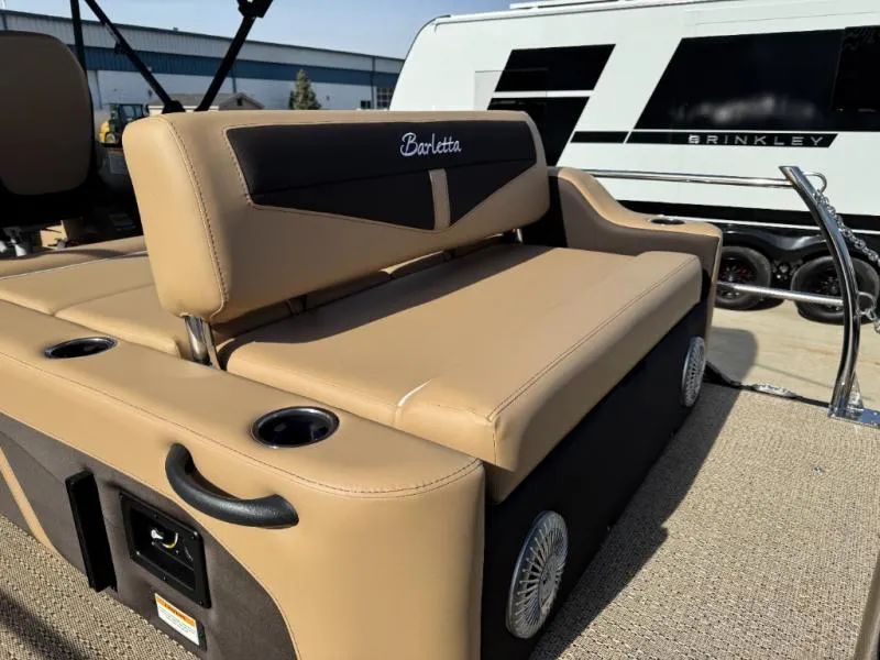 Slide: The Image of Luxurious seating on 2025 Cabrio Ultra-Entertainer C24UE boat, featuring tan upholstery and cup holders. - 16