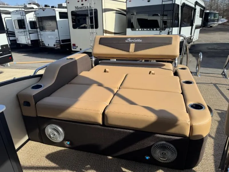 Slide: The Image of Luxurious Cabrio Ultra-Entertainer C24UE boat seating, 2025 model, with tan cushions and cup holders. - 17