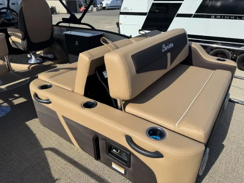Slide: The Image of 2025 Cabrio Ultra-Entertainer C24UE boat interior with tan seating and cup holders. - 19