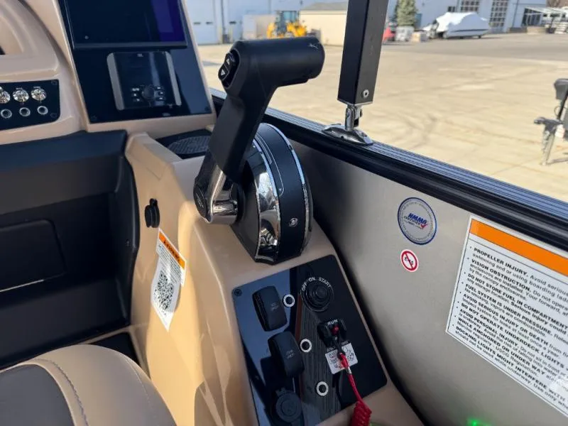 Slide: The Image of Control panel of 2025 Cabrio Ultra-Entertainer C24UE boat with throttle and switches. - 23
