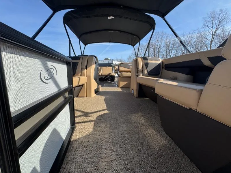 Slide: The Image of 2025 Cabrio Ultra-Entertainer C24UE interior with spacious seating and canopy under clear sky. - 8