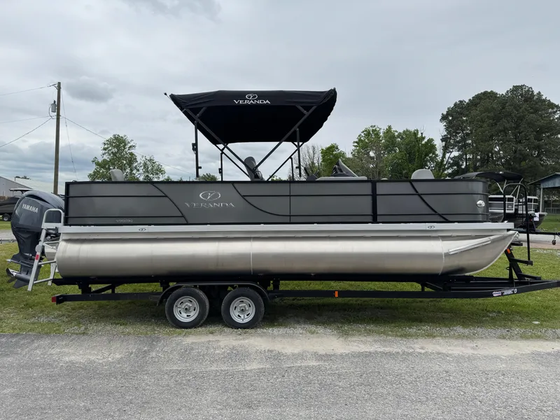 Slide: The Image of 2025 Veranda Fish VF22F4 pontoon boat on trailer, parked outdoors. - 1