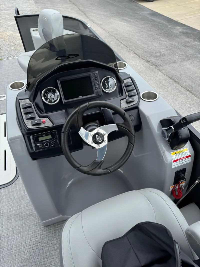 Slide: The Image of 2025 Veranda Fish VF22F4 boat dashboard with steering wheel and control panel. - 5