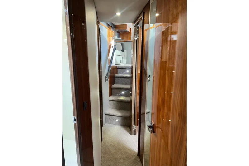 Slide: The Image of 2020 Maritimo M51 yacht interior hallway with wooden finishes and carpeted stairs. - 102