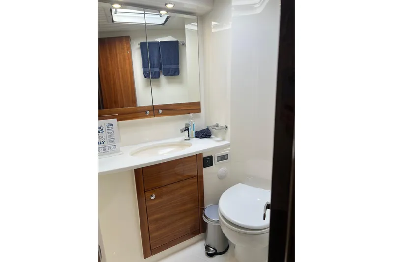 Slide: The Image of Luxurious bathroom in 2020 Maritimo M51 yacht with modern fixtures and wooden accents. - 103