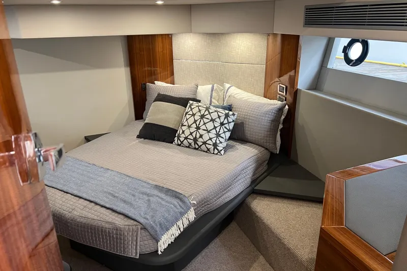 Slide: The Image of Luxurious bedroom interior of 2020 Maritimo M51 yacht with elegant bedding and wood accents. - 105