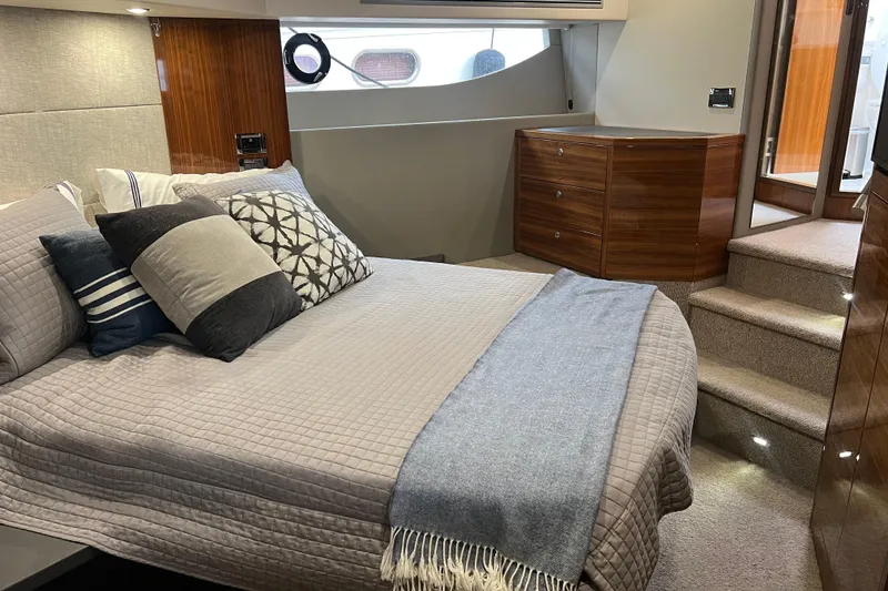 Slide: The Image of Luxurious bedroom interior of 2020 Maritimo M51 yacht with elegant bedding and wooden accents. - 109