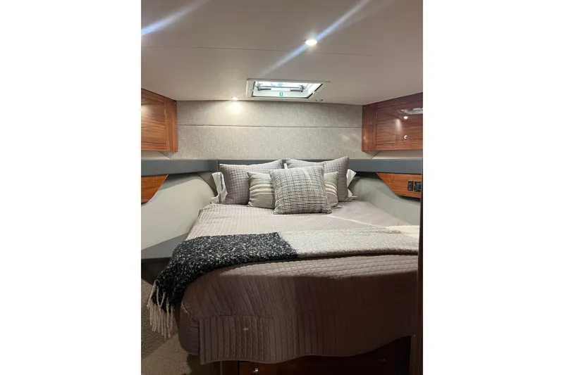 Slide: The Image of Luxurious cabin interior of 2020 Maritimo M51 yacht with cozy bedding and elegant wood finishes. - 112