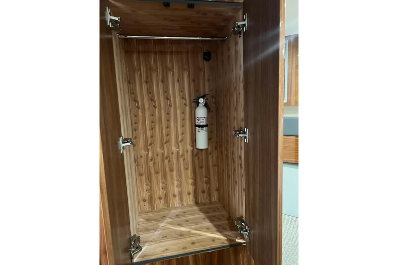 Slide: The Image of Wooden cabinet interior with fire extinguisher in 2020 Maritimo M51 yacht. - 115