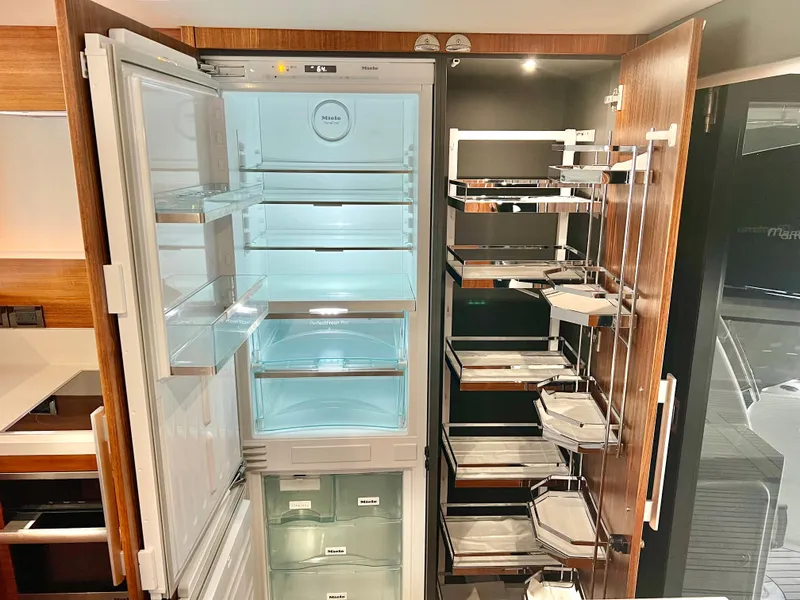 Slide: The Image of Modern kitchen with open fridge and pantry in 2020 Maritimo M51 yacht. - 33