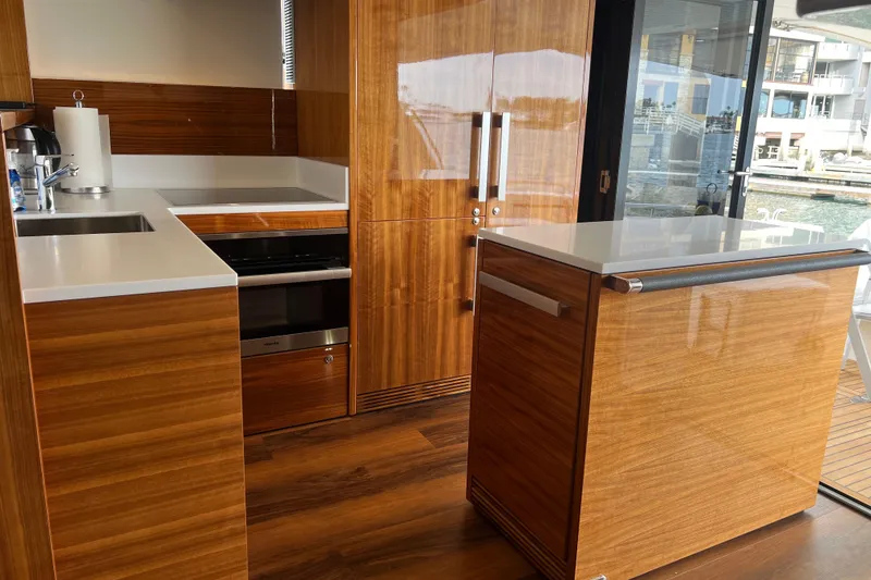 Slide: The Image of Luxurious 2020 Maritimo M51 yacht kitchen with sleek wood cabinetry and modern appliances. - 78