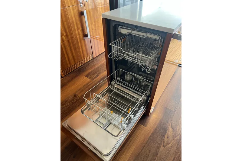 Slide: The Image of Open dishwasher in 2020 Maritimo M51 yacht kitchen with wooden flooring. - 88