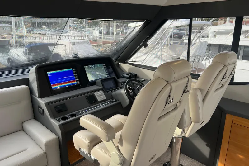 Slide: The Image of 2020 Maritimo M51 yacht helm with dual screens and luxurious seating. - 90
