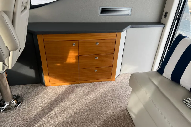 Slide: The Image of Interior of 2020 Maritimo M51 yacht with wooden cabinetry and striped cushion. - 93