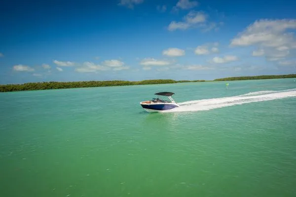 Slide: The Image of 2025 Yamaha Boats 252SD cruising on turquoise water under a clear blue sky. - 5