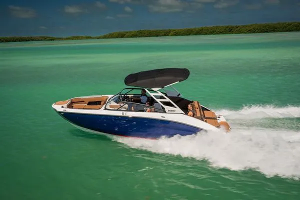 Slide: The Image of 2025 Yamaha Boats 252SD cruising on turquoise water under a clear sky. - 6
