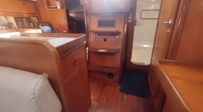Slide: The Image of Interior of 1990 Beneteau Oceanis 390 sailboat with wooden cabinetry and seating. - 12