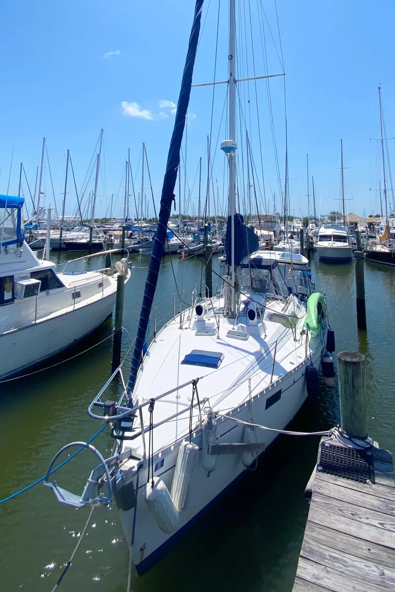 Slide: The Image of 1990 Beneteau Oceanis 390 sailboat docked at marina under clear blue sky. - 2