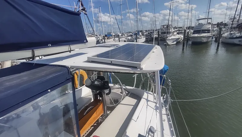 Slide: The Image of Beneteau Oceanis 390 sailboat with solar panel, docked in a marina, 1990 model. - 31