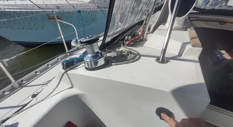 Slide: The Image of Cockpit view of a 1990 Beneteau Oceanis 390 sailboat, featuring winch and ropes. - 33