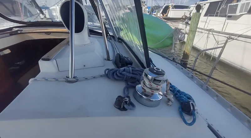 Slide: The Image of Beneteau Oceanis 390 sailboat deck with winch and ropes, docked at marina, 1990 model. - 34