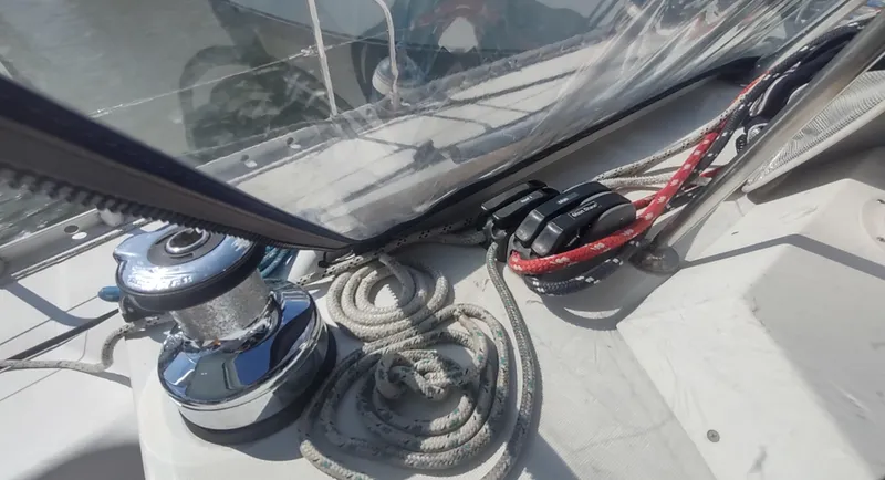 Slide: The Image of Close-up of Beneteau Oceanis 390 sailboat deck, featuring winch and ropes, 1990 model. - 36