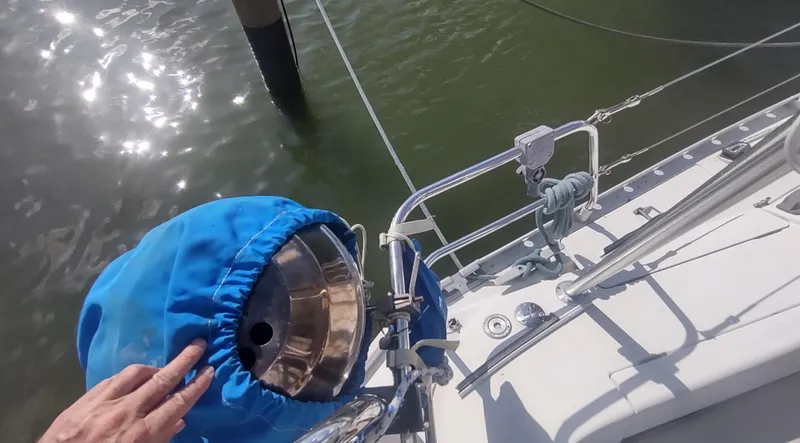 Slide: The Image of Beneteau Oceanis 390 sailboat deck with blue cover, docked in sunlight, 1990 model. - 42