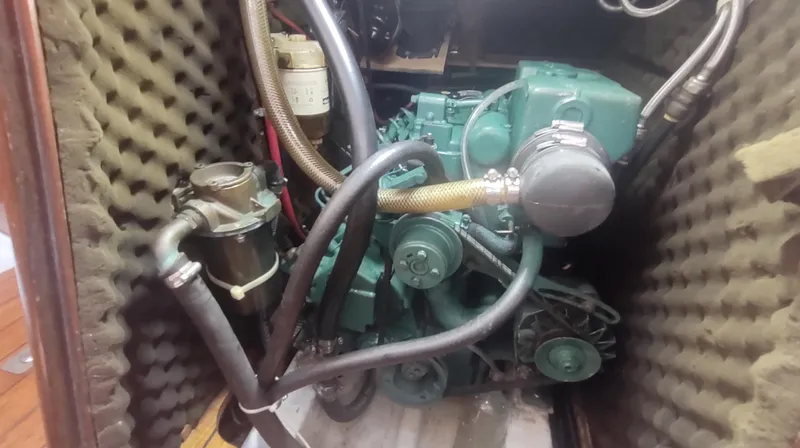 Slide: The Image of Engine compartment of a 1990 Beneteau Oceanis 390 sailboat, showcasing mechanical components. - 43