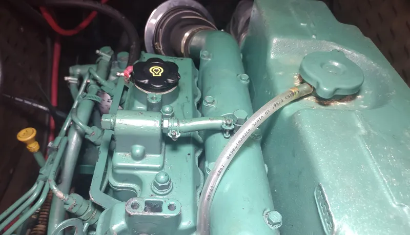 Slide: The Image of Engine of a 1990 Beneteau Oceanis 390 sailboat, showcasing mechanical components. - 44