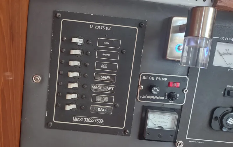 Slide: The Image of Control panel of a 1990 Beneteau Oceanis 390 sailboat with switches and bilge pump. - 47