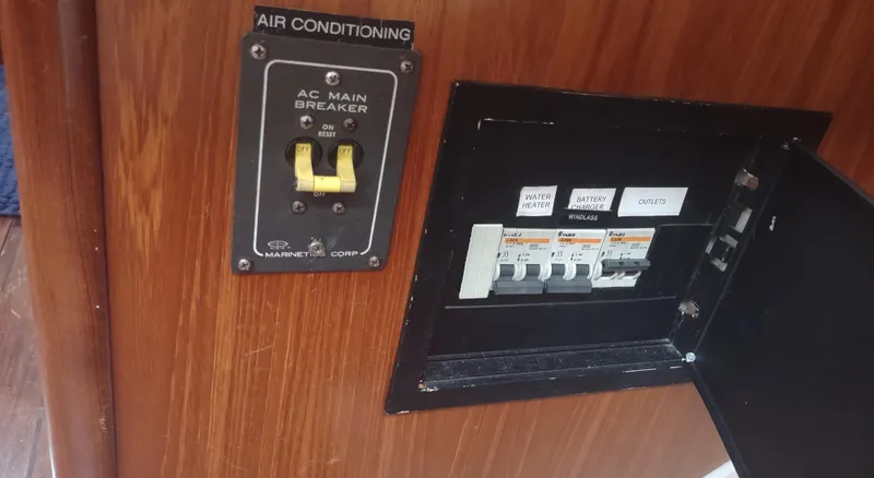 Slide: The Image of AC main breaker panel on 1990 Beneteau Oceanis 390 yacht interior. - 48